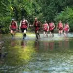 Group of adventure trail runners in a river in Costa Rica