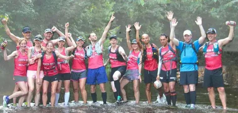 Group of adventure runners in a river in Costa Rica