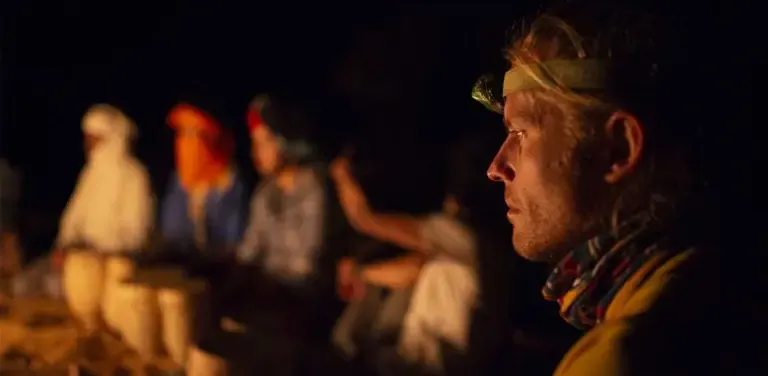 Man listening to drums in the desert