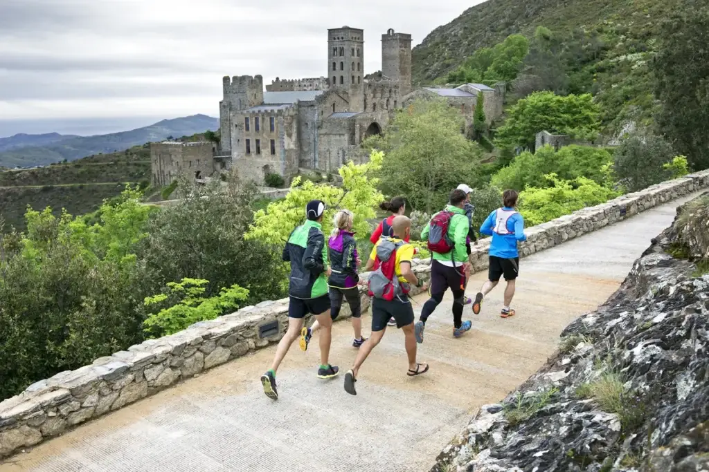The group running past a medieval castle and gardens