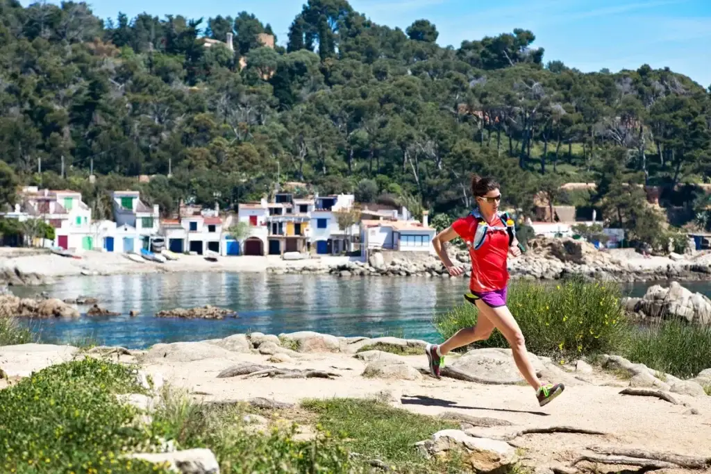Runner passing the fishermen's houses on the Costa Brava
