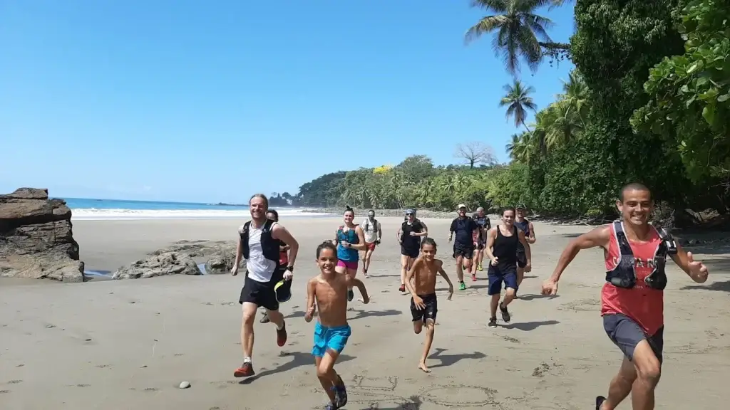 The group running onto a wild Pacific beach