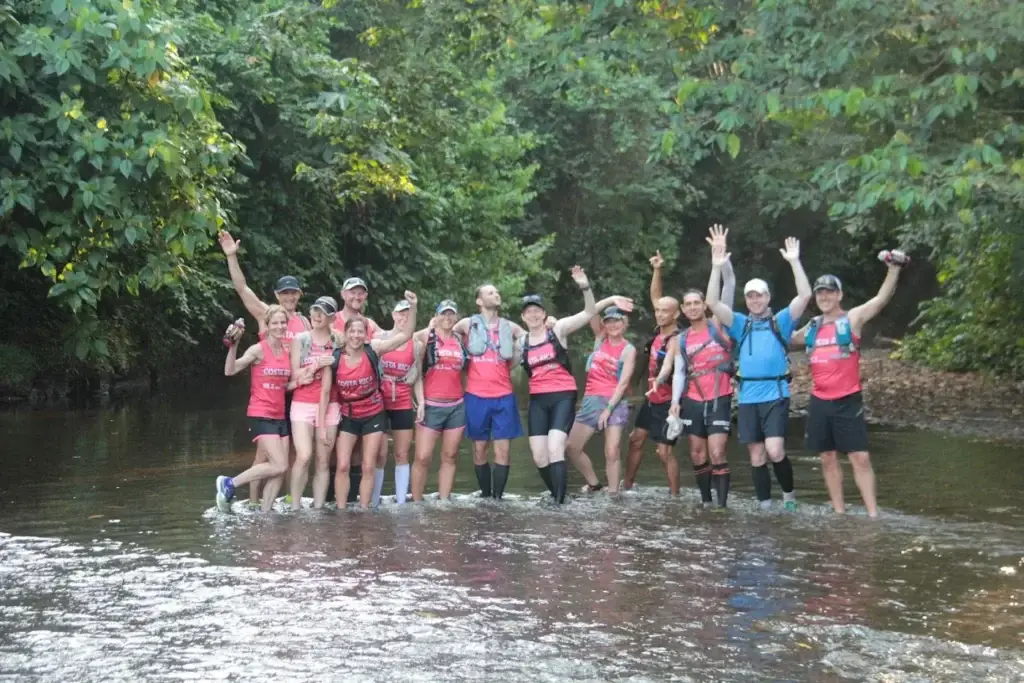 The whole group celebrating in a jungle river