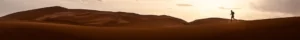 A lone runner crossing the dunes at dusk