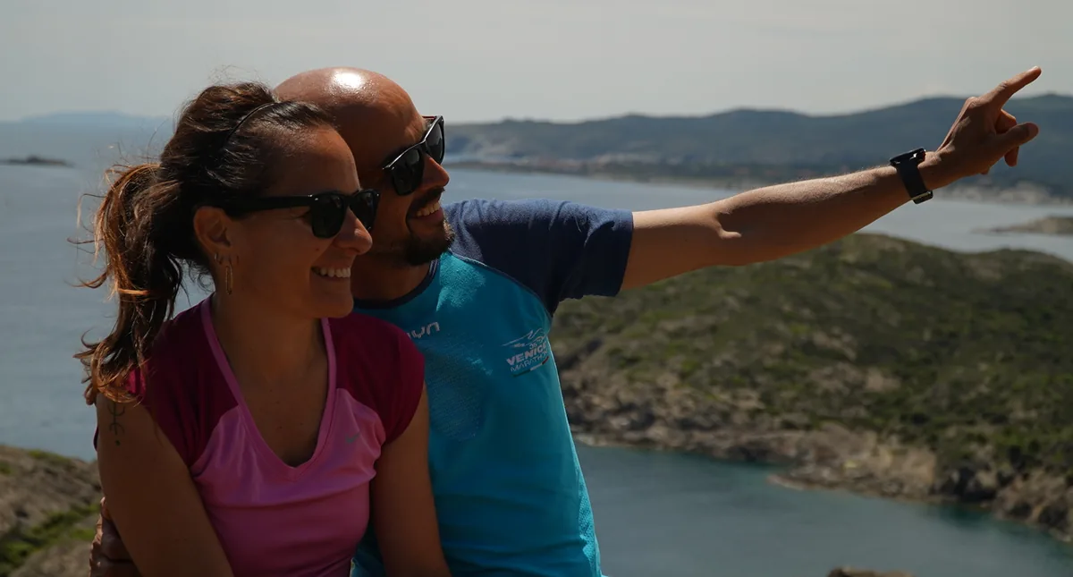 Pablo and Cristina on a headland above the Costa Brava, Pablo pointing out across the water