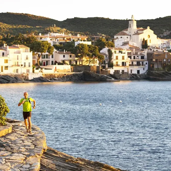 A runner on the coast path above Cadaques at sunrise