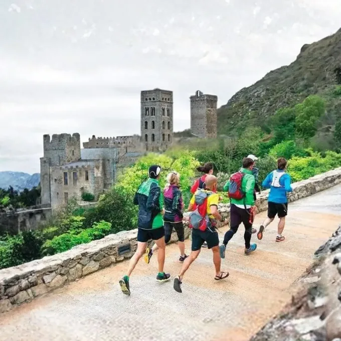 The group running past a Romanesque monastery on the Pyrenean route